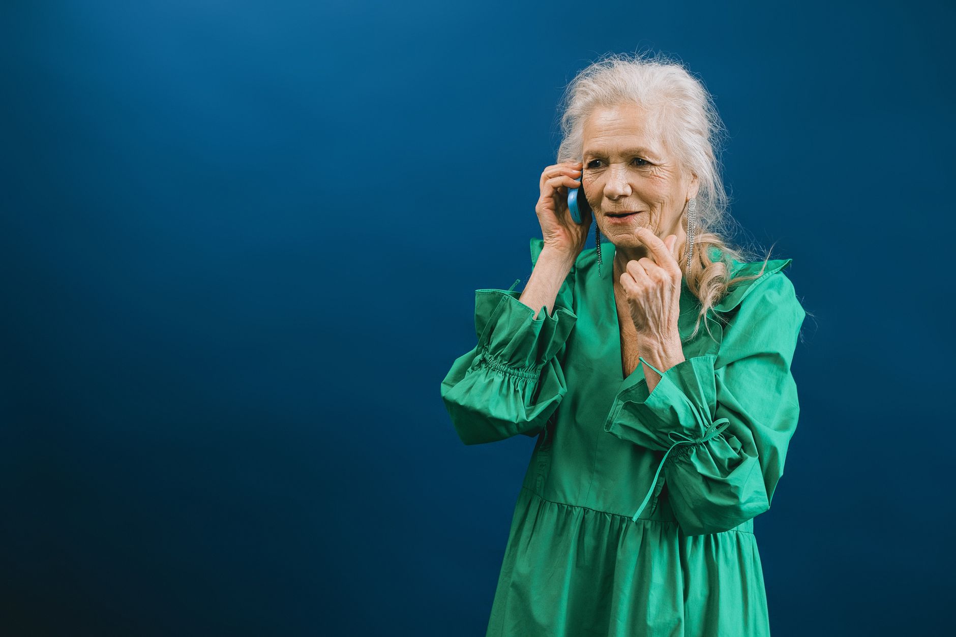 elderly woman looking at a saved contact on her smartphone