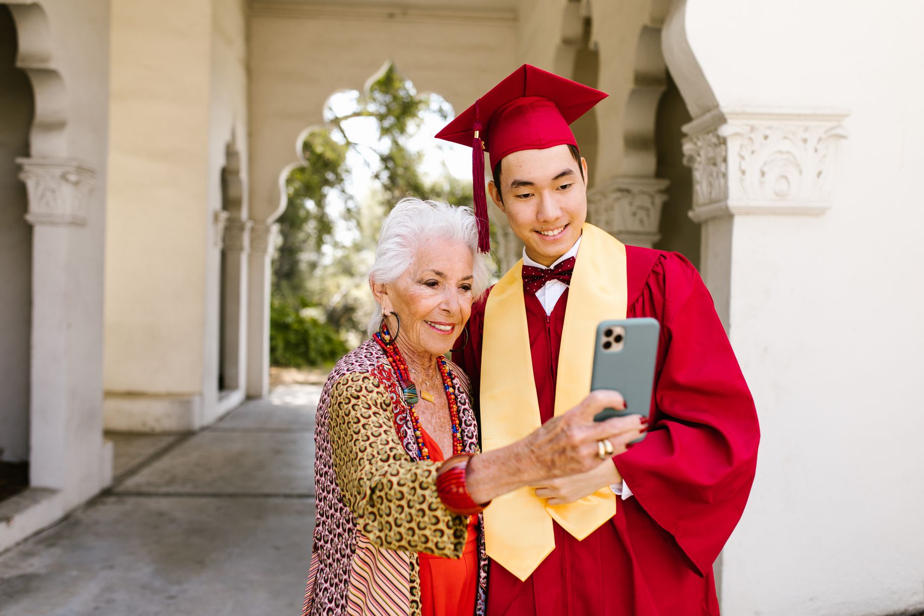 grandson showing grandmother privacy settings on a smartphone