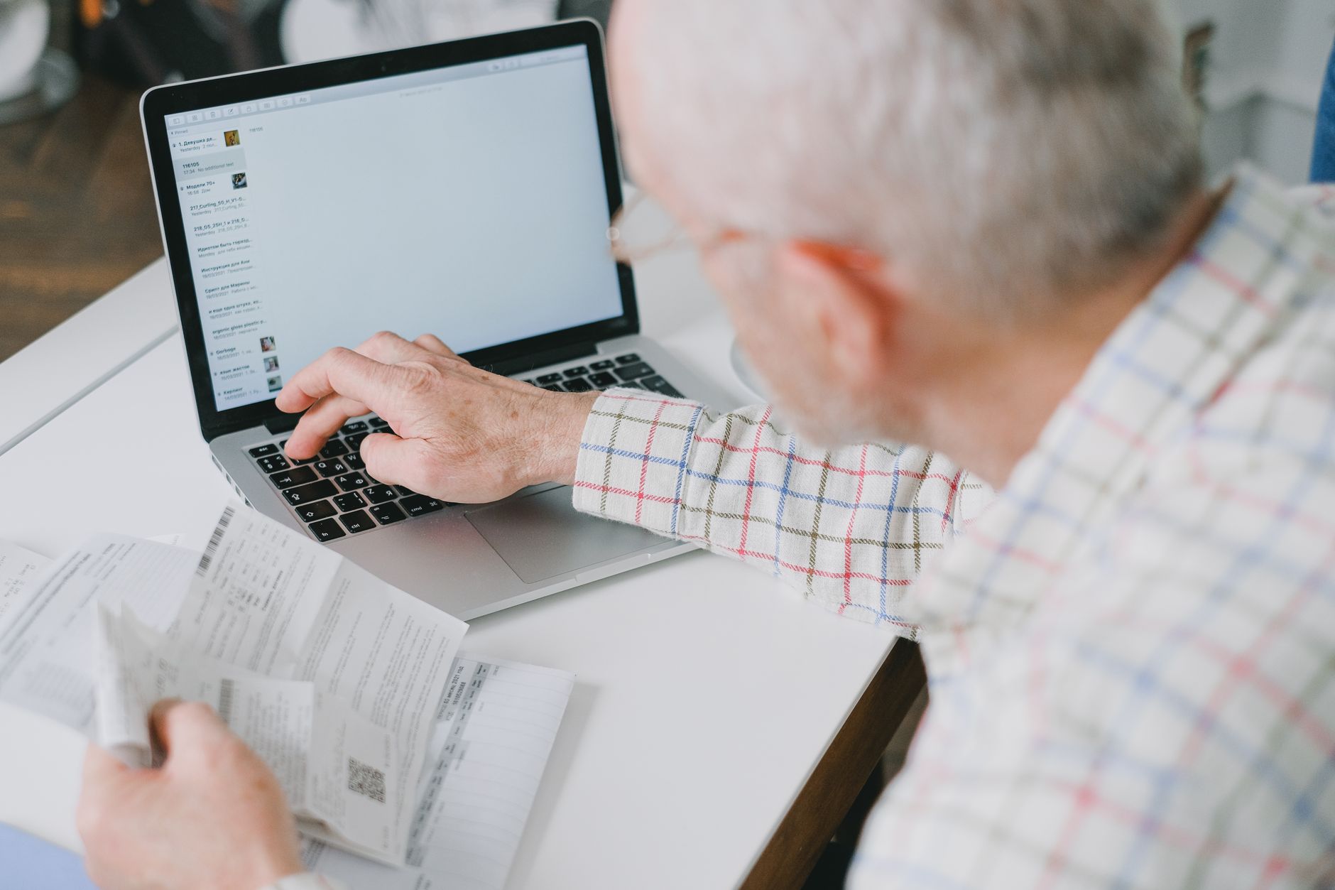 A person looking closely at a laptop screen to check a website URL