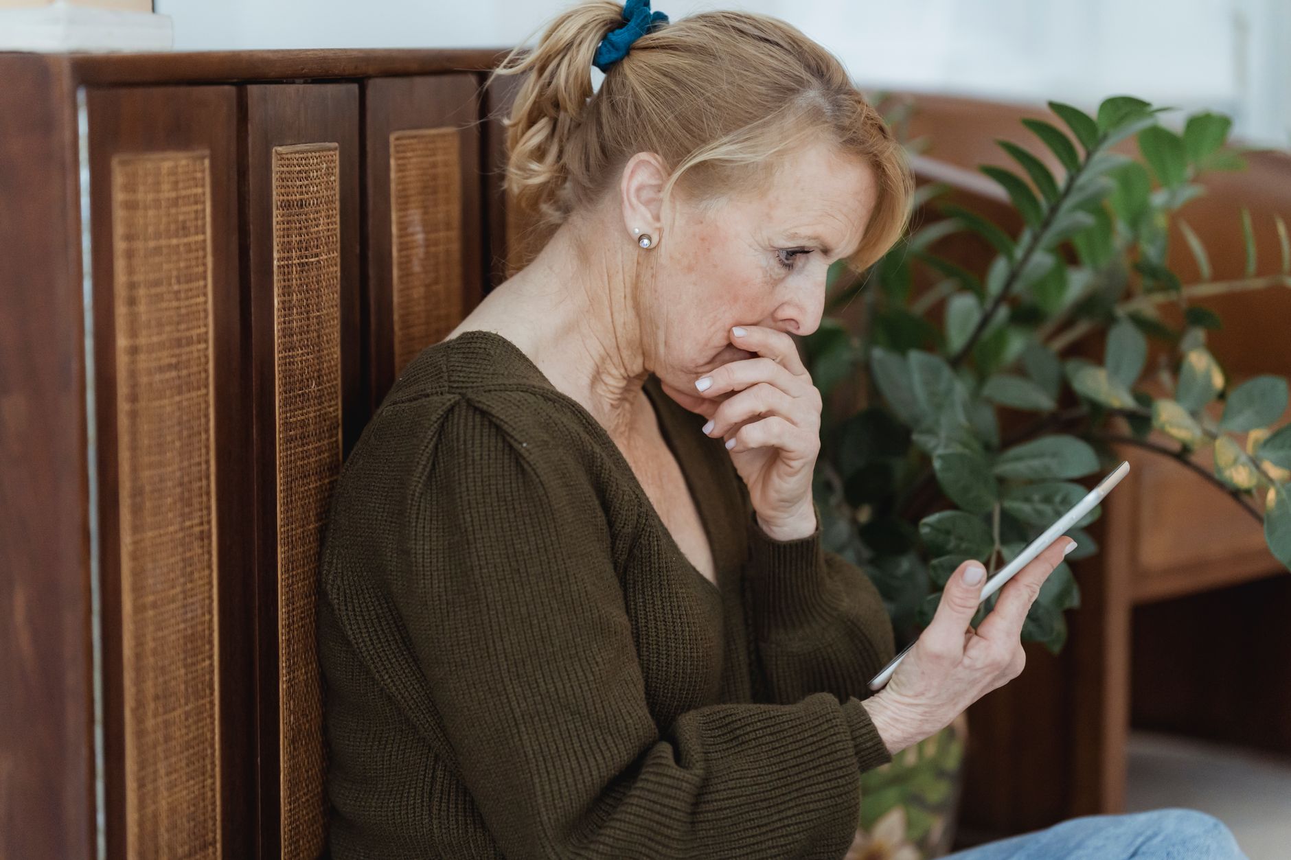A person reading a privacy policy on a phone screen with a concerned look
