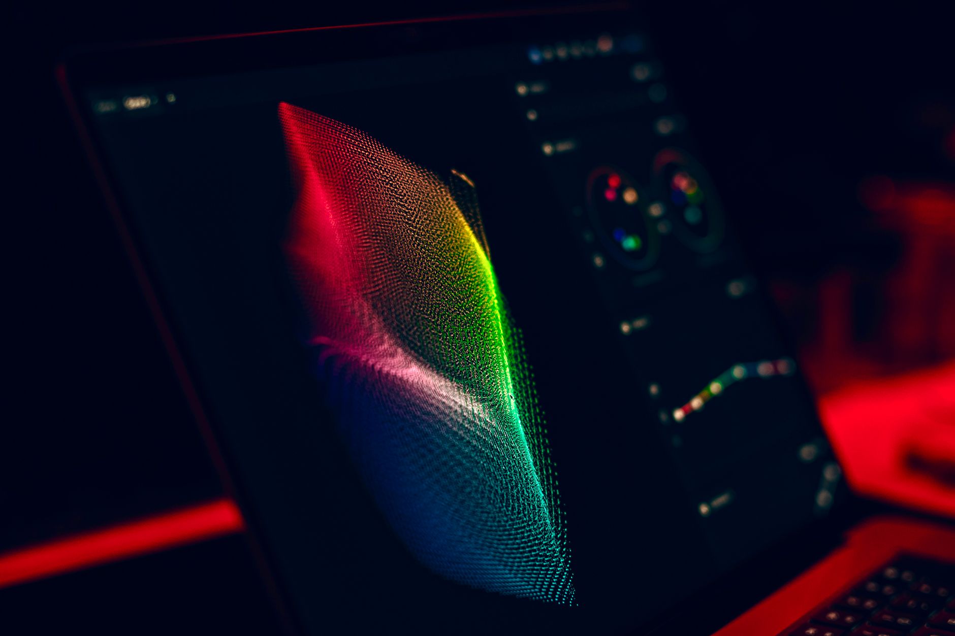 A laptop screen displays a distorted digital face during a video editing session