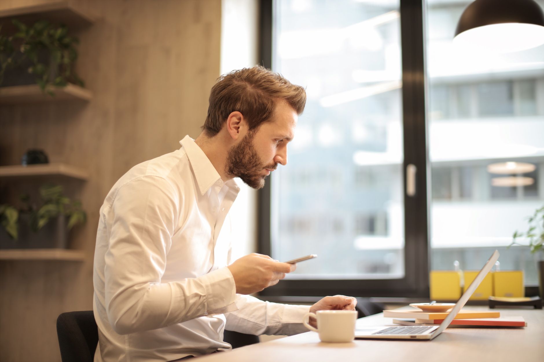 Person reading unexpected email on laptop with a concerned expression